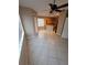 Open dining area with tile flooring, leading to the kitchen area, and large windows at 19239 Stone Hedge Dr, Tampa, FL 33647
