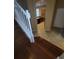 Inviting entryway features hardwood stairs, tiled flooring, and a view into the kitchen at 19239 Stone Hedge Dr, Tampa, FL 33647