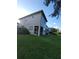Rear exterior view of a two-story townhome with a screened-in patio and well-maintained lawn at 19239 Stone Hedge Dr, Tampa, FL 33647
