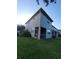 Back exterior of a two-story townhome with a screened patio and well-kept lawn at 19239 Stone Hedge Dr, Tampa, FL 33647