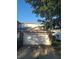 Attached two-car garage with a white door and stone accents, providing convenient parking at 19239 Stone Hedge Dr, Tampa, FL 33647