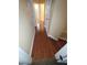 Hallway with hardwood flooring leading to rooms with neutral-colored walls at 19239 Stone Hedge Dr, Tampa, FL 33647