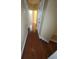 Hallway with hardwood flooring leading to rooms with neutral-colored walls at 19239 Stone Hedge Dr, Tampa, FL 33647