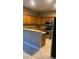 A bright kitchen featuring tile floors, stainless steel appliances, and warm oak cabinetry at 19239 Stone Hedge Dr, Tampa, FL 33647