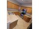 Well-equipped kitchen with stainless steel appliances, wooden cabinetry, and tile flooring at 19239 Stone Hedge Dr, Tampa, FL 33647
