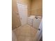Functional laundry room with washer, dryer, tile floor, and convenient storage options at 19239 Stone Hedge Dr, Tampa, FL 33647