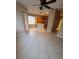 Open-concept living room showcasing tile floors and seamlessly connected to the kitchen at 19239 Stone Hedge Dr, Tampa, FL 33647