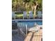 Relaxing poolside view with striped lounge chairs and serene blue water at 19239 Stone Hedge Dr, Tampa, FL 33647