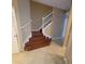 A beautiful staircase features wood steps, white risers, and white railings at 19239 Stone Hedge Dr, Tampa, FL 33647