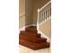 A wood staircase with white banister and carpet runner leading to the next floor at 19239 Stone Hedge Dr, Tampa, FL 33647