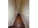 Wooden staircase leading downwards with white railing and neutral walls at 19239 Stone Hedge Dr, Tampa, FL 33647