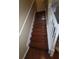 Hardwood stairs with a white railing lead to the second floor of the home at 19239 Stone Hedge Dr, Tampa, FL 33647