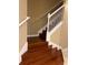 Hardwood staircase with white railing in a home with neutral wall colors at 19239 Stone Hedge Dr, Tampa, FL 33647
