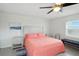 Bedroom featuring a pink bed, white headboard, and modern decor with plenty of natural light at 2306 41St E St, Bradenton, FL 34208