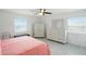Bright bedroom featuring a pink bed, stylish dresser, and ample natural light from two windows at 2306 41St E St, Bradenton, FL 34208