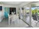 Open dining room showcasing a white table and chairs near sliding glass doors to the patio at 2306 41St E St, Bradenton, FL 34208