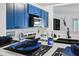 Stylish kitchen boasts blue cabinets, quartz countertops, stainless steel appliances, and modern fixtures at 2306 41St E St, Bradenton, FL 34208