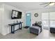 Inviting living room features modern furniture, a flat-screen TV, and an entryway with a bright-blue door at 2306 41St E St, Bradenton, FL 34208