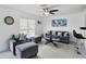 Cozy living room with neutral tones, modern furniture, ceiling fan, and natural light from the window at 2306 41St E St, Bradenton, FL 34208