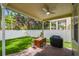 Charming covered patio with outdoor seating, grill, and lush green grass and garden at 2506 S Obrapia St, Tampa, FL 33629