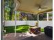 Covered patio with outdoor seating, grill, and lush garden. Perfect for backyard barbecues at 2506 S Obrapia St, Tampa, FL 33629