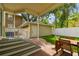 Inviting backyard with patio, dining set, green lawn, and detached garage at 2506 S Obrapia St, Tampa, FL 33629