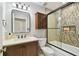Bathroom showcasing a shower over bath, vanity with dark wood cabinets, and stylish tile work at 2506 S Obrapia St, Tampa, FL 33629