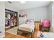 A bedroom featuring hardwood floors, ample storage, and a workspace for a activities at 2506 S Obrapia St, Tampa, FL 33629