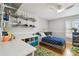 Cozy bedroom with a white ceiling fan, colorful rug, and built-in shelves for organized toy storage at 2506 S Obrapia St, Tampa, FL 33629