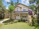 Inviting two-story home featuring a cozy front porch and lush landscaping at 2506 S Obrapia St, Tampa, FL 33629