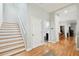 Bright hallway featuring wood floors, stairs, and access to a half-bath at 2506 S Obrapia St, Tampa, FL 33629