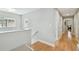 Bright hallway featuring hardwood floors and neutral wall paint leading to various rooms in the home at 2506 S Obrapia St, Tampa, FL 33629