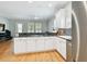 Bright kitchen features stainless steel appliances, white cabinets, tile backsplash and granite countertops at 2506 S Obrapia St, Tampa, FL 33629