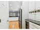 View of the kitchen featuring stainless steel appliances, white cabinets, and hardwood floors at 2506 S Obrapia St, Tampa, FL 33629