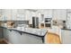 Modern kitchen with white cabinets, stainless appliances, island bar and tile backsplash at 2506 S Obrapia St, Tampa, FL 33629