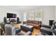 Comfortable living room area with leather furniture, media console and bright natural lighting at 2506 S Obrapia St, Tampa, FL 33629