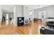 View of the open living area with hardwood floors, a piano, and a connected dining space at 2506 S Obrapia St, Tampa, FL 33629