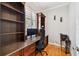 Home office features custom built-in bookshelves and granite-topped desk for a functional workspace at 2506 S Obrapia St, Tampa, FL 33629