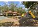 Community playground featuring slides, climbing wall, covered picnic area and basketball court at 2506 S Obrapia St, Tampa, FL 33629