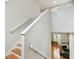Staircase and landing offers a glimpse into the music room with a piano and additional seating at 2506 S Obrapia St, Tampa, FL 33629