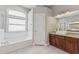 Bathroom with soaking tub, vanity with granite countertop, vessel sink and window allowing for natural light at 25946 Buckthorn Ave, Land O Lakes, FL 34639