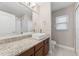 Bright bathroom featuring granite countertops, vessel sink, a window, and a walk-in shower at 25946 Buckthorn Ave, Land O Lakes, FL 34639