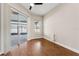 Bedroom showcasing hardwood floors, a large window and a sliding glass door at 25946 Buckthorn Ave, Land O Lakes, FL 34639