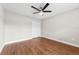 The empty bedroom features hardwood floors, a ceiling fan, and a closet for convenience at 25946 Buckthorn Ave, Land O Lakes, FL 34639