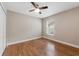 A cozy bedroom featuring a ceiling fan, warm paint, and a bright window offering natural light at 25946 Buckthorn Ave, Land O Lakes, FL 34639