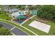 Aerial view of a community center with a pool, playground, and sand volleyball court at 25946 Buckthorn Ave, Land O Lakes, FL 34639