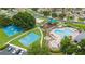 Aerial view of community amenities featuring a pool, hot tub, playground, and basketball courts at 25946 Buckthorn Ave, Land O Lakes, FL 34639