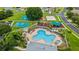 Aerial view of community amenities featuring a pool, hot tub, playground, volleyball court and basketball courts at 25946 Buckthorn Ave, Land O Lakes, FL 34639