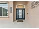 Close-up of the home's front door with sidelights, transom window, address numbers, and stylish exterior finish at 25946 Buckthorn Ave, Land O Lakes, FL 34639