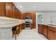 Spacious kitchen featuring wooden cabinetry, granite countertops, and modern stainless steel appliances at 25946 Buckthorn Ave, Land O Lakes, FL 34639